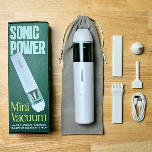 Sonic Power mini vacuum cleaner with accessories on a wooden surface
