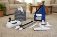 Set of Element central vacuum carpet cleaning tools including a hose, nozzles, and a bag on a carpeted floor in living room