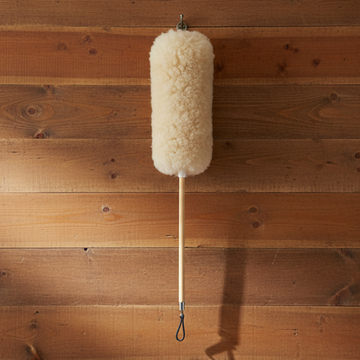 Lambswool duster hanging on a wooden wall