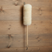 Lambswool duster hanging on a wooden wall