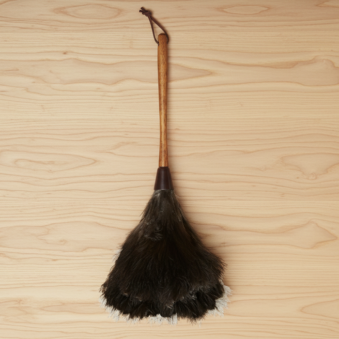 Traditional ostrich feather duster on a wooden surface