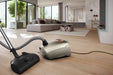 Miele Titanium PF Vacuum cleaner on a wooden floor in a modern living room. Miele Guard L1 Electro Titanium PF SUFE0 Canister Vacuum Cleaner Capital Vacuum Raleigh Cary NC