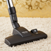 Miele vacuum cleaner head on a carpet with a decorative wall in the background. Miele Homecare Classic C1  Canister Vacuum Cleaner Capital Vacuum Raleigh Cary NC