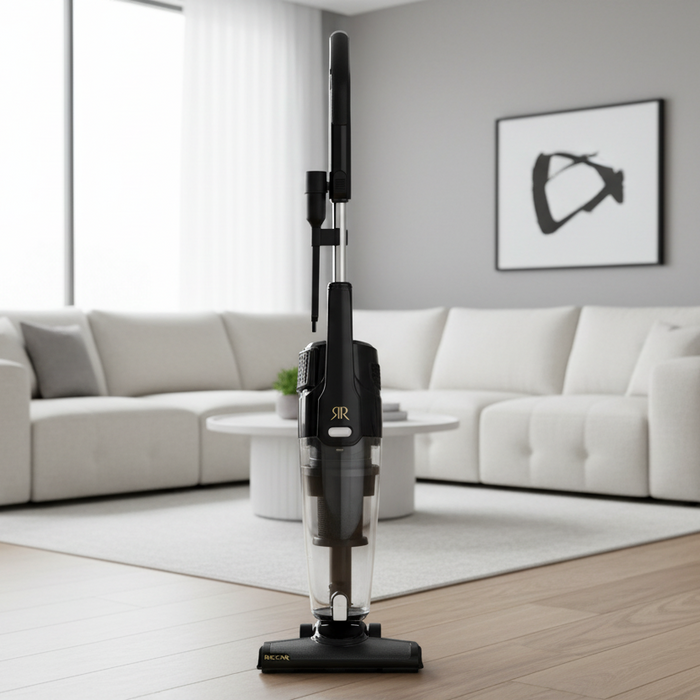 Riccar R60 black stick vacuum cleaner on a wooden floor in a modern living room.