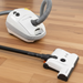 Sebo E3 White vacuum cleaner with a long hose on a wooden floor