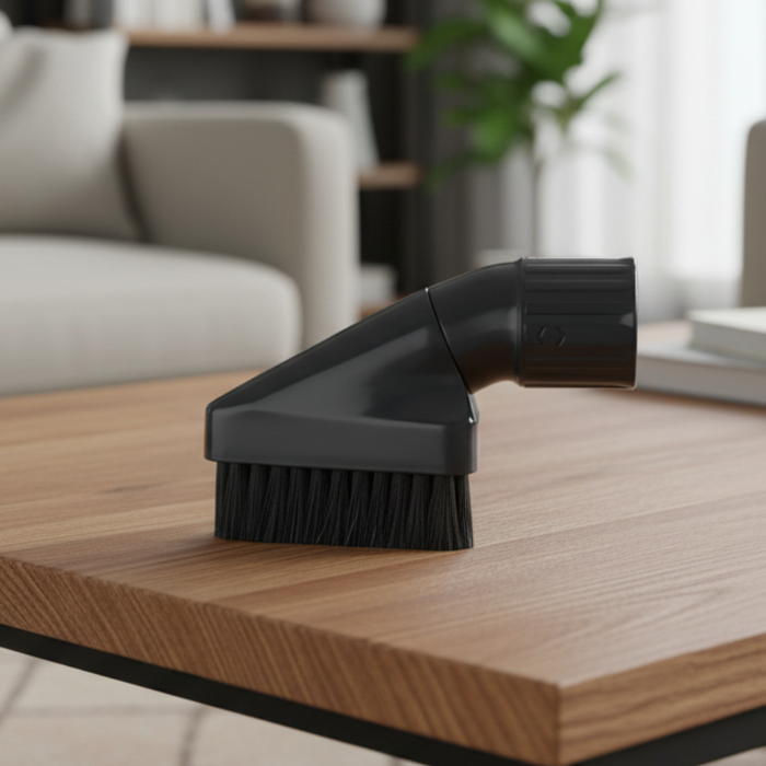 Black vacuum brush on a wooden table with a blurred living room . Sebo Airbelt K3 Premium Red Canister Vacuum 90687AM Capital Vacuum Raleigh Cary NCbackground