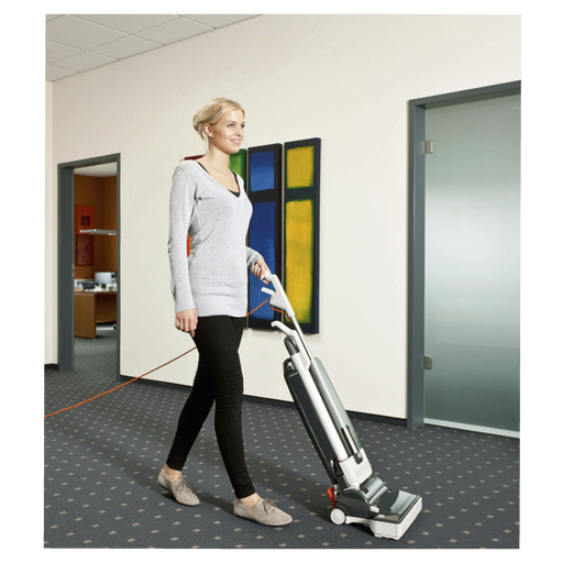 Woman using a vacuum cleaner in an office setting. Sebo G4 Commercial Upright Vacuum 90406AM Capital Vacuum Raleigh Cary NC