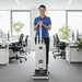 Person cleaning an office floor with a vacuum cleaner. Sebo G4 Commercial Upright Vacuum 90406AM Capital Vacuum Raleigh Cary NC