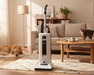 Sebo Vacuum cleaner in a living room with a dog and cat, and a coffee table with a cup.