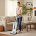 Smiling woman vacuum living room  with Sebo X4 Upright Vacuum 9570AM White Capital Vacuum Raleigh Cary NC