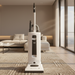 White vacuum cleaner on a carpeted floor in a modern living room. Sebo X4 Upright Vacuum 9570AM White Capital Vacuum Raleigh Cary NC