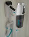 Simplicity brand handheld vacuum cleaner attached to a wall mount on a white background. Simplicity S67 cordless vacuum cleaner. Capital Vacuum Raleigh Cary NC