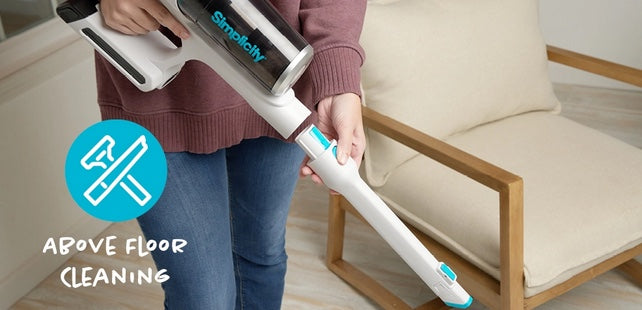 Person using a Simplicity S67 vacuum in a home setting with text 'Above Floor Cleaning'. Simplicity S67 cordless vacuum cleaner. Capital Vacuum Raleigh Cary NC