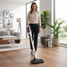 Woman using Miele Triflex HX2 Cordless White SMOLO upright mode in living room square. Capital Vacuum Raleigh Cary NC