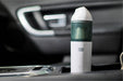 Handheld vacuum cleaner with 'Sonic Power' branding on a car dashboard.